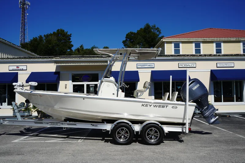 The Image of 2024 Key West 210 Bay Reef boat on trailer, parked outside dealership. - 0
