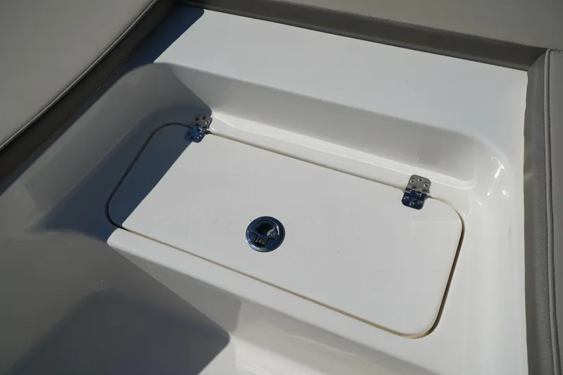 Slide: The Image of 2024 Key West 210 Bay Reef storage compartment with secure latch and hinges. - 10