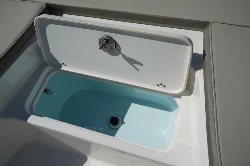 Slide: The Image of 2024 Key West 210 Bay Reef boat storage compartment with open lid. - 11
