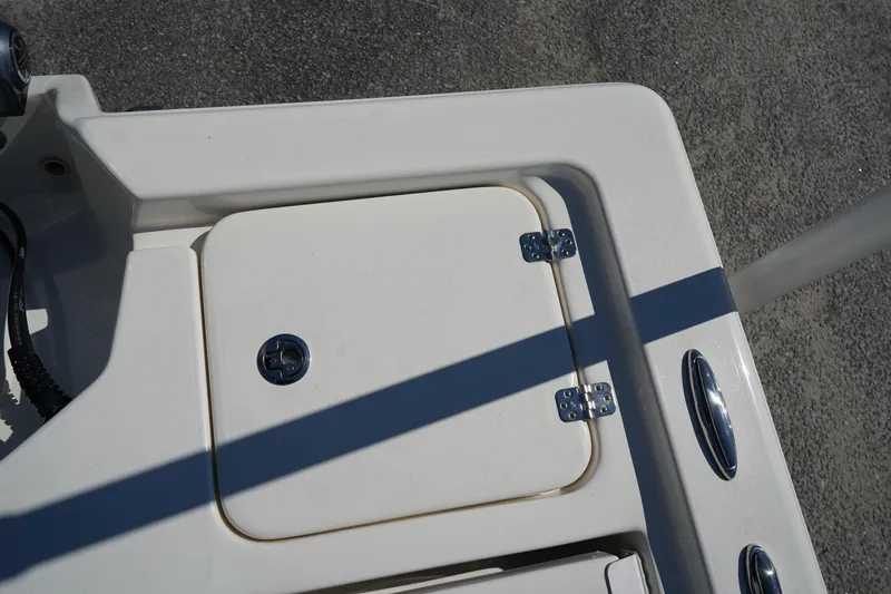 Slide: The Image of 2024 Key West 210 Bay Reef boat deck with storage compartment and hinges. - 12