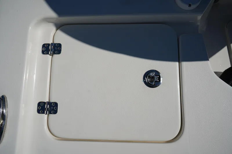 Slide: The Image of 2024 Key West 210 Bay Reef boat hatch with metal hinges and latch. - 14