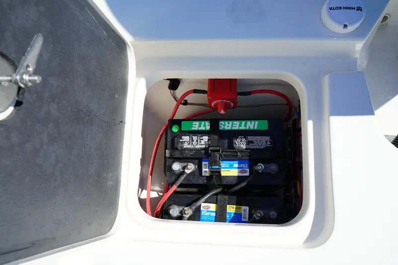 Slide: The Image of Battery compartment of 2024 Key West 210 Bay Reef boat, featuring dual batteries. - 15
