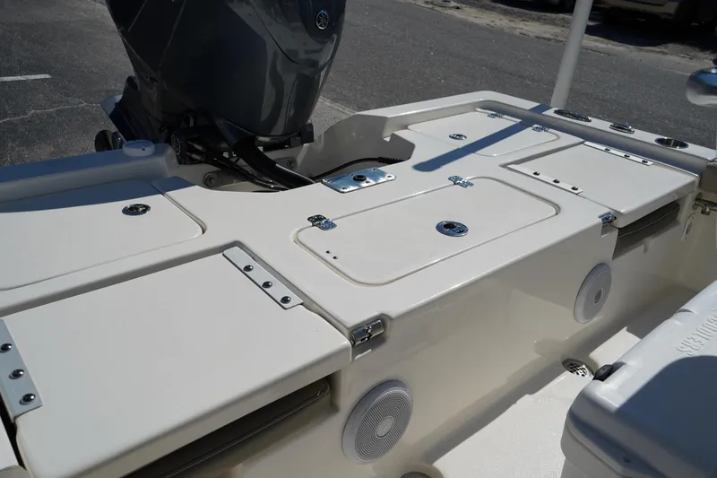 Slide: The Image of 2024 Key West 210 Bay Reef boat deck with storage compartments and motor. - 18