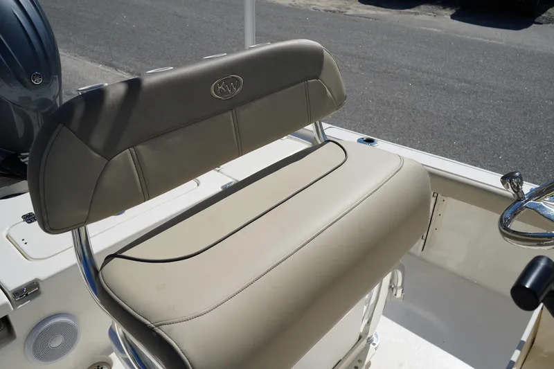 Slide: The Image of 2024 Key West 210 Bay Reef boat seat with beige upholstery and chrome accents. - 24
