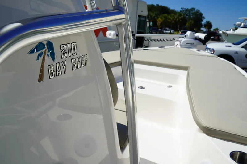 Slide: The Image of 2024 Key West 210 Bay Reef boat, close-up of logo and deck in sunlight. - 28
