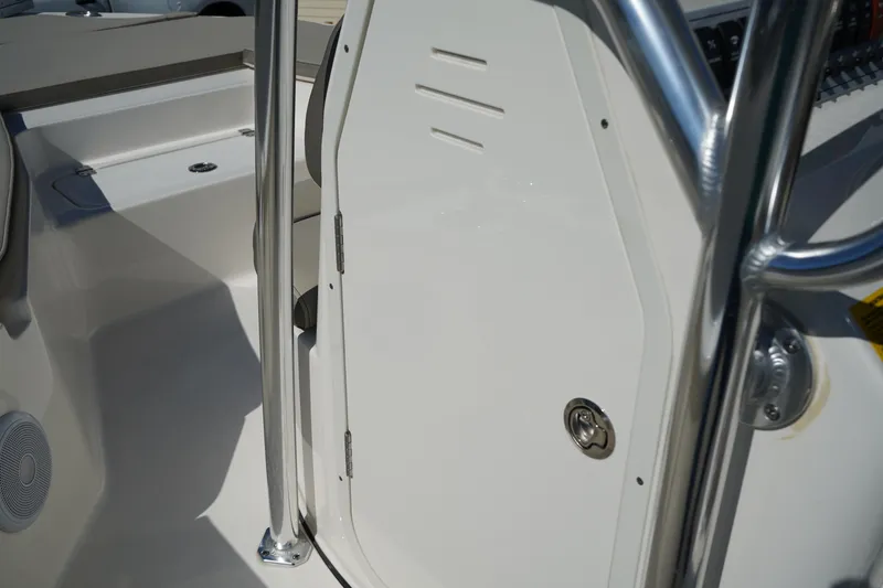 Slide: The Image of 2024 Key West 210 Bay Reef boat interior with stainless steel railing and storage compartment. - 29