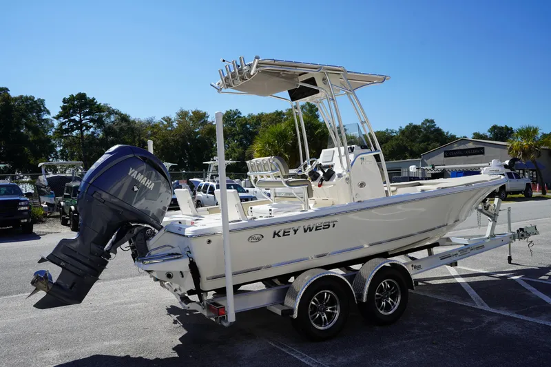 Slide: The Image of 2024 Key West 210 Bay Reef boat with Yamaha engine on trailer in sunny outdoor setting. - 3