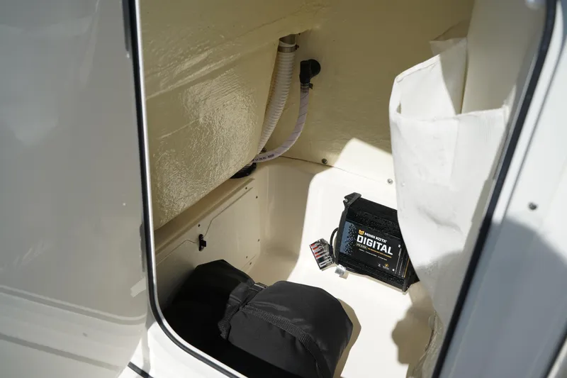 Slide: The Image of 2024 Key West 210 Bay Reef boat storage compartment with digital equipment. - 30