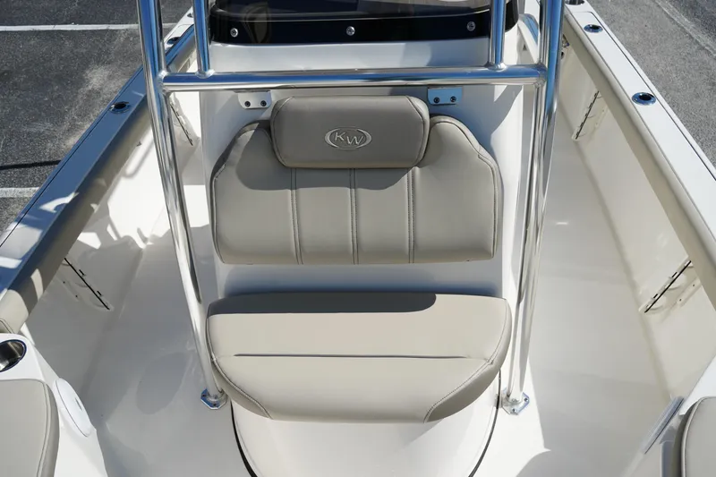 Slide: The Image of 2024 Key West 210 Bay Reef boat seating area with beige cushions and stainless steel frame. - 32