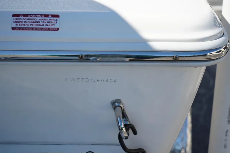 Slide: The Image of 2024 Key West 210 Bay Reef boat stern with warning label and serial number. - 38