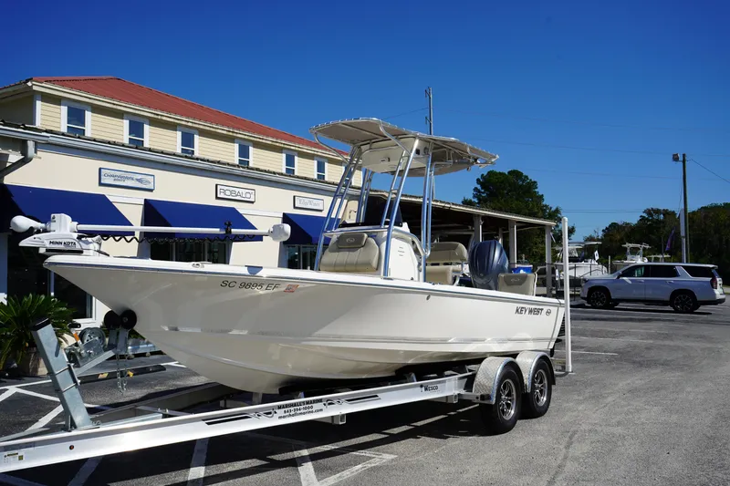 Slide: The Image of 2024 Key West 210 Bay Reef boat on trailer outside dealership. - 4