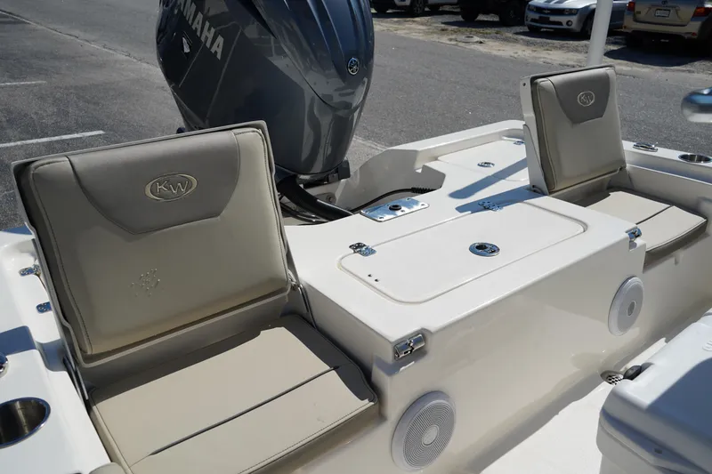 Slide: The Image of 2024 Key West 210 Bay Reef boat interior with Yamaha engine, featuring cushioned seating and storage. - 7