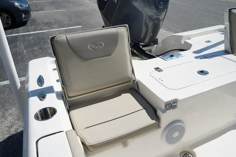 Slide: The Image of 2024 Key West 210 Bay Reef boat interior with cushioned seating and storage compartments. - 8