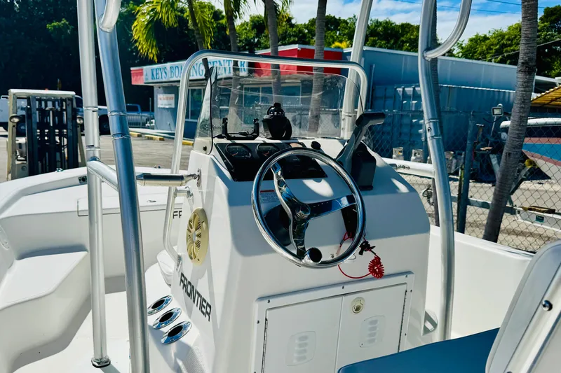 Slide: The Image of 2014 Frontier 180 boat interior with steering wheel and control panel. - 5