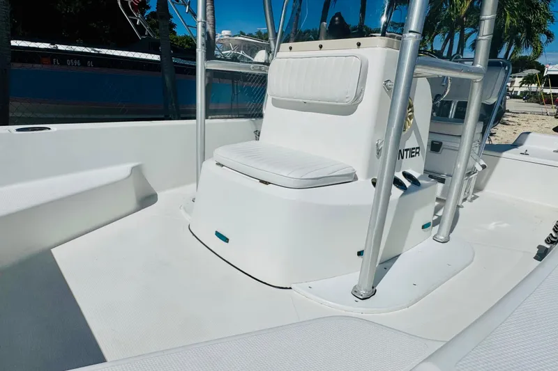 Slide: The Image of 2014 Frontier 180 boat interior with white seating and console. - 7