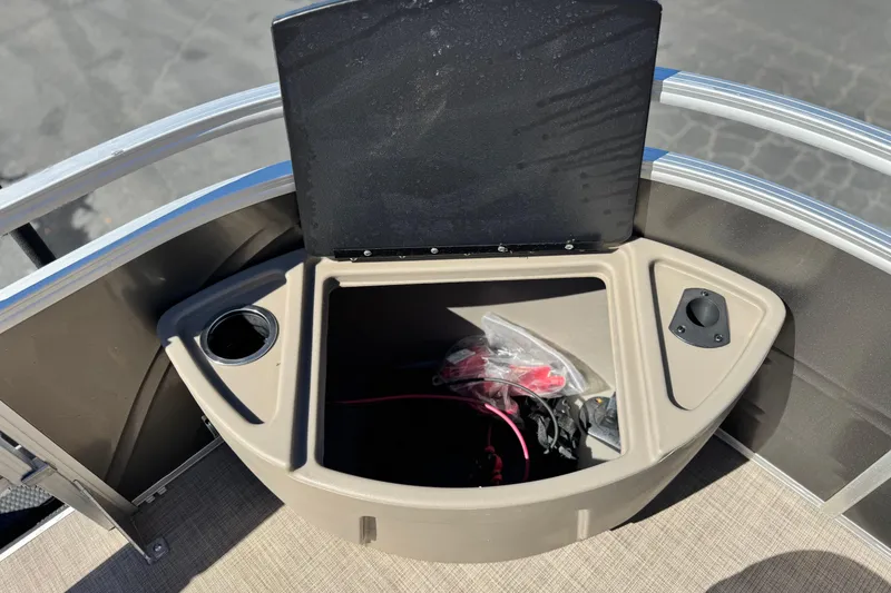 Slide: The Image of 2024 Sun Tracker Fishin' Barge 20 DLX storage compartment with cup holders and accessories. - 14