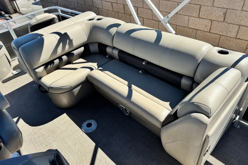 Slide: The Image of 2024 Sun Tracker Fishin' Barge 20 DLX, beige seating area with cup holders. - 18