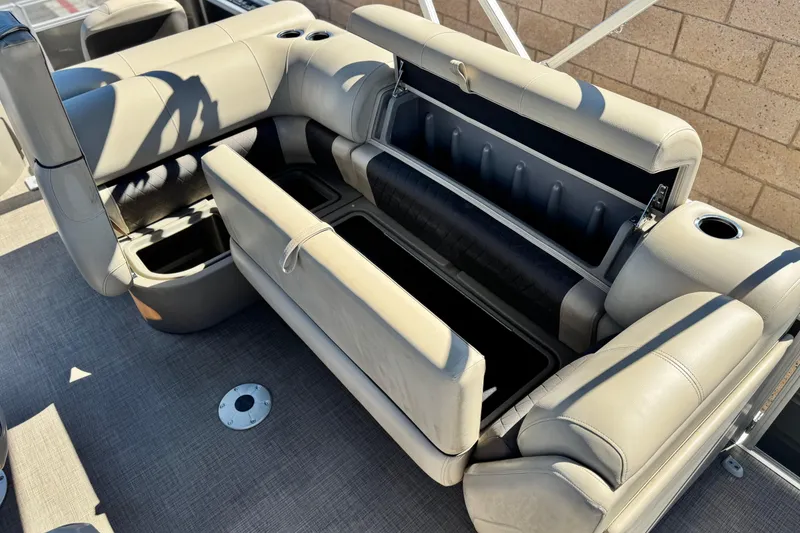 Slide: The Image of 2024 Sun Tracker Fishin' Barge 20 DLX interior with open storage compartments. - 19