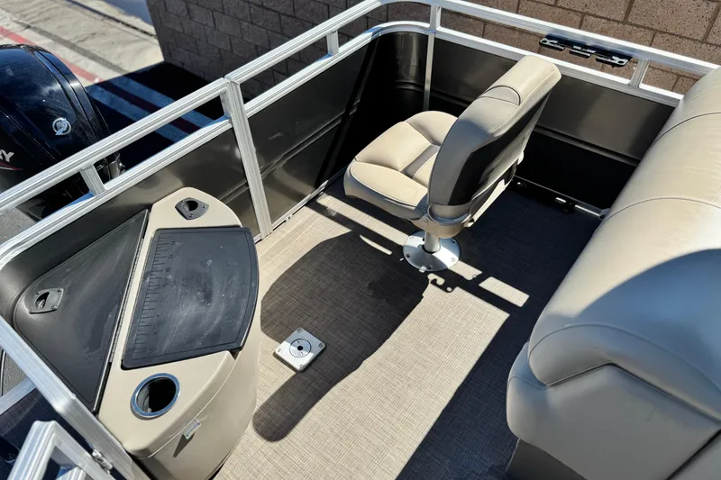 Slide: The Image of 2024 Sun Tracker Fishin' Barge 20 DLX interior with seating and fishing station. - 20