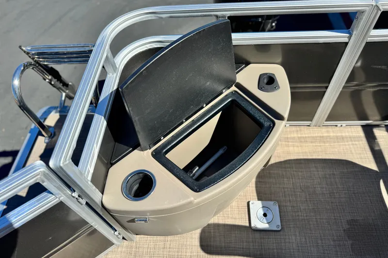 Slide: The Image of 2024 Sun Tracker Fishin' Barge 20 DLX storage compartment with cup holder and railing. - 21