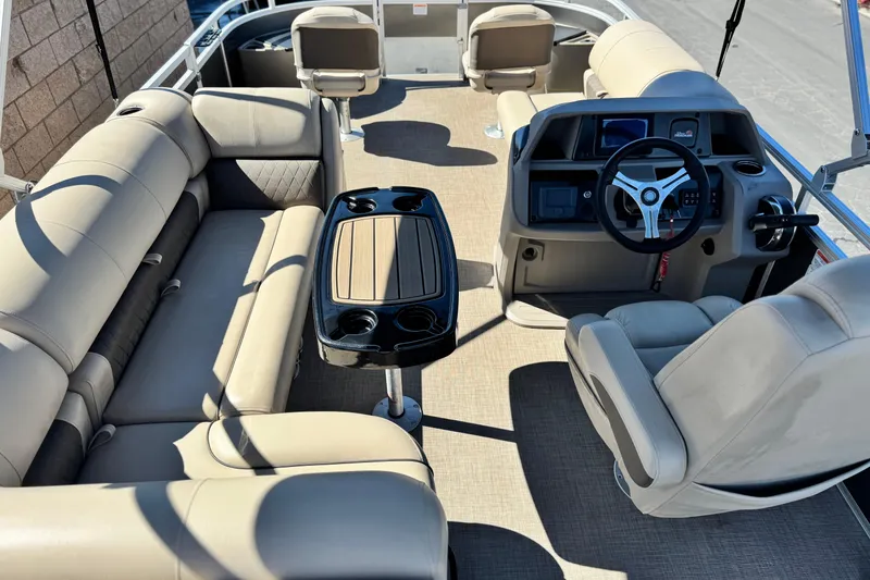 Slide: The Image of 2024 Sun Tracker Fishin' Barge 20 DLX interior with seating and steering console. - 22