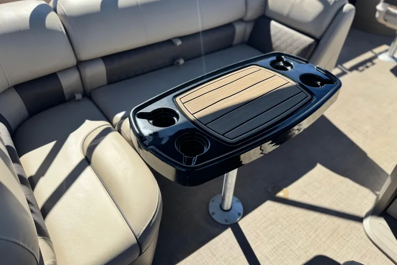 Slide: The Image of 2024 Sun Tracker Fishin' Barge 20 DLX interior with table and cup holders. - 23