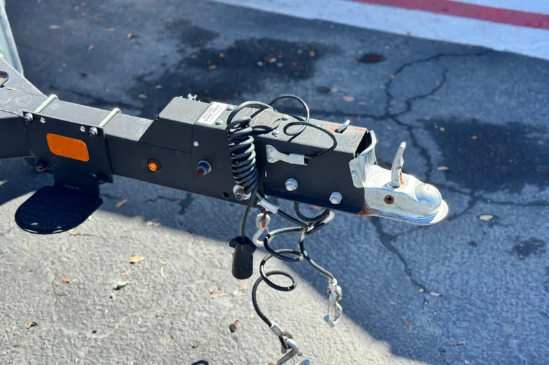 Slide: The Image of Trailer hitch of 2024 Sun Tracker Fishin' Barge 20 DLX on asphalt surface. - 28