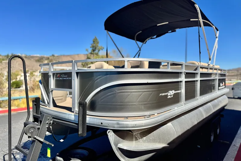 Slide: The Image of 2024 Sun Tracker Fishin' Barge 20 DLX pontoon boat with canopy on trailer. - 3