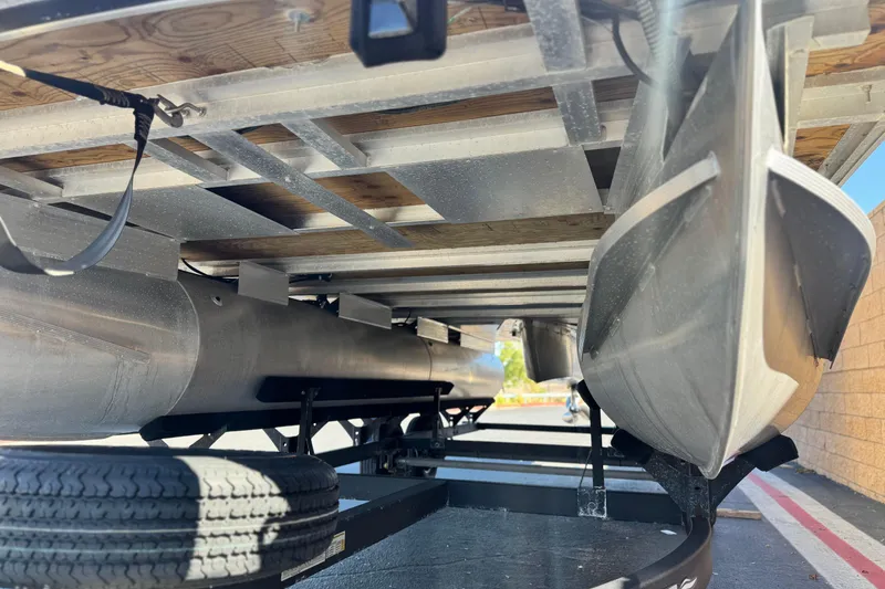 Slide: The Image of Underneath view of 2024 Sun Tracker Fishin' Barge 20 DLX pontoon boat on trailer. - 4