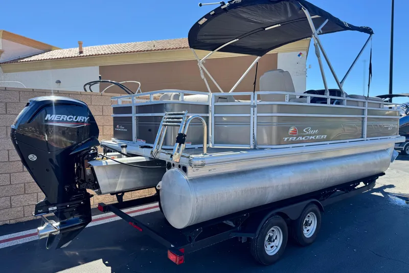 Slide: The Image of 2024 Sun Tracker Fishin' Barge 20 DLX pontoon boat with Mercury outboard motor. - 6