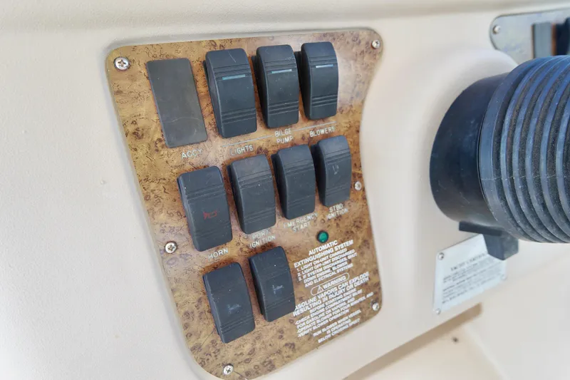 Slide: The Image of Control panel of a 2000 Sea Ray 280 Sundancer boat with labeled switches. - 10