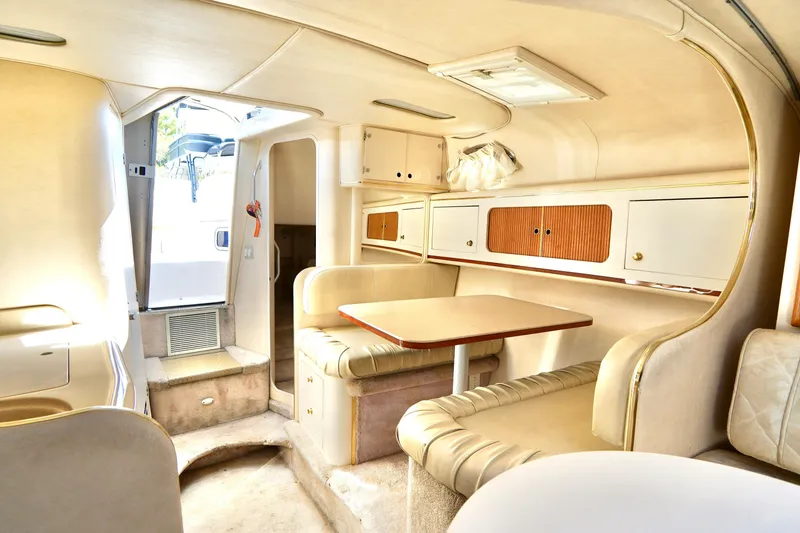Slide: The Image of Interior cabin of 2000 Sea Ray 280 Sundancer, featuring cozy sleeping area and storage shelves. - 20