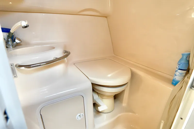 Slide: The Image of Interior of 2000 Sea Ray 280 Sundancer, featuring a cozy dining area with white cabinetry. - 23