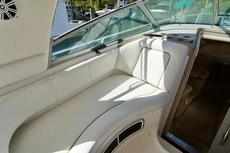 Slide: The Image of Interior seating of 2000 Sea Ray 280 Sundancer boat, featuring white leather upholstery. - 27