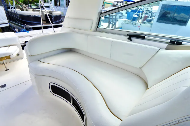 Slide: The Image of Interior view of a 2000 Sea Ray 280 Sundancer boat with white seating. - 28