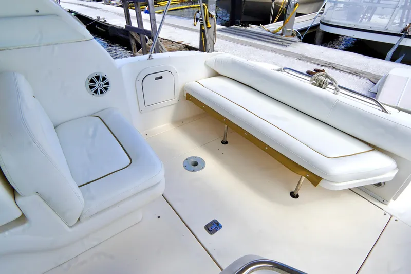 Slide: The Image of 2000 Sea Ray 280 Sundancer boat docked at marina, featuring beige canopy and sleek design. - 33