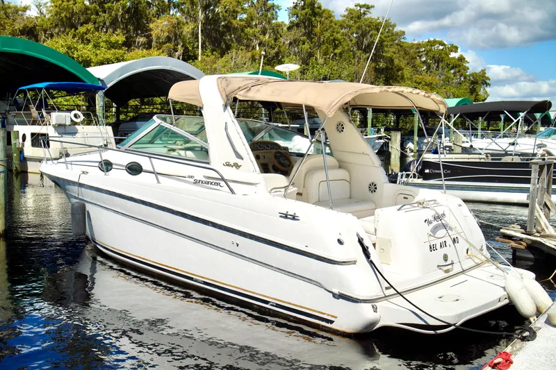 Slide: The Image of 2000 Sea Ray 280 Sundancer boat docked, featuring spacious cockpit and elegant design. - 34