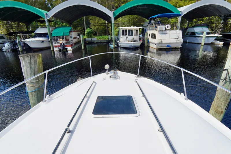 Slide: The Image of Bow view of 2000 Sea Ray 280 Sundancer docked at marina with covered slips. - 5