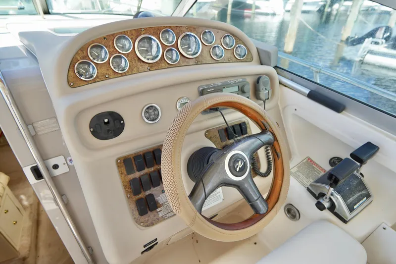 Slide: The Image of Cockpit of 2000 Sea Ray 280 Sundancer with steering wheel and control panel. - 9