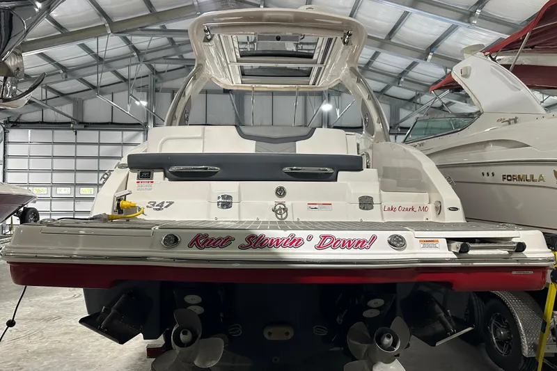 Slide: The Image of 2021 Chaparral 347 SSX boat in a garage, rear view with "Knot Slowin' Down!" text. - 13