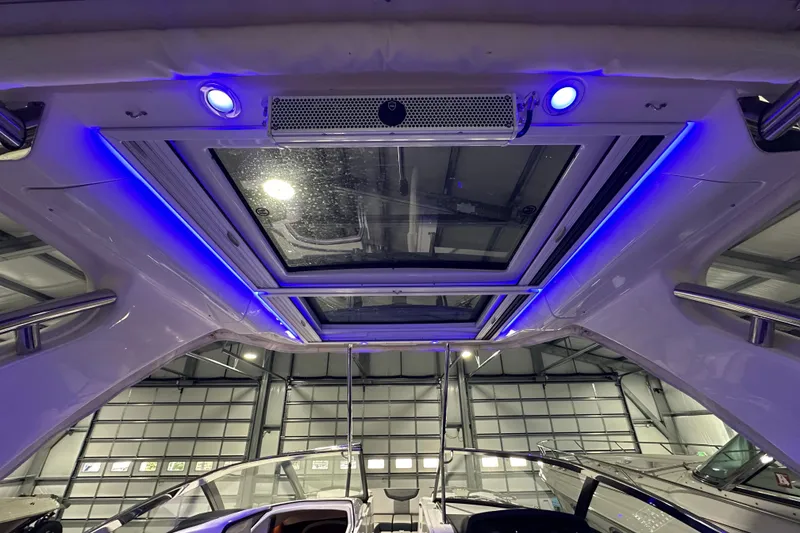 Slide: The Image of Interior view of 2021 Chaparral 347 SSX boat with blue LED lighting and sunroof. - 17