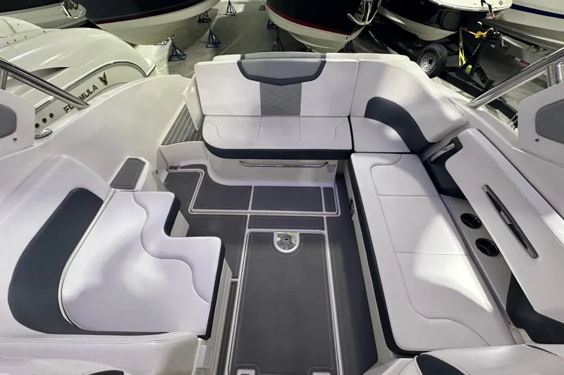 Slide: The Image of 2021 Chaparral 347 SSX boat interior with white and gray seating arrangement. - 18
