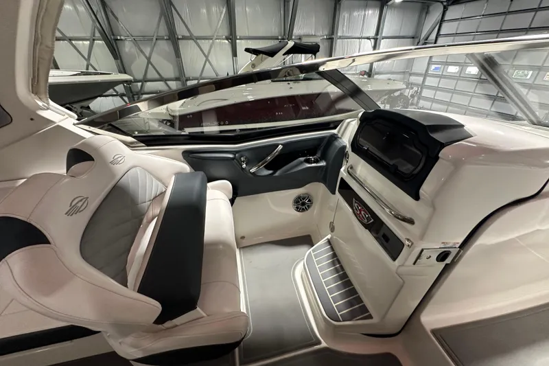Slide: The Image of 2021 Chaparral 347 SSX boat interior with sleek dashboard and comfortable seating. - 21