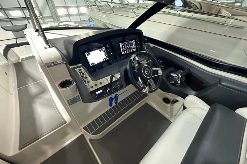 Slide: The Image of 2021 Chaparral 347 SSX boat cockpit with modern dashboard and steering wheel. - 23