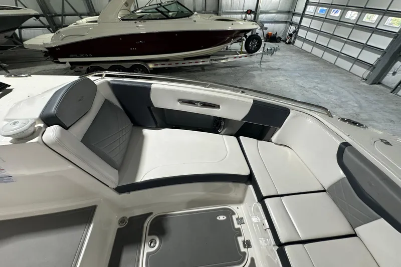 Slide: The Image of 2021 Chaparral 347 SSX boat interior with luxurious seating in a spacious garage. - 26