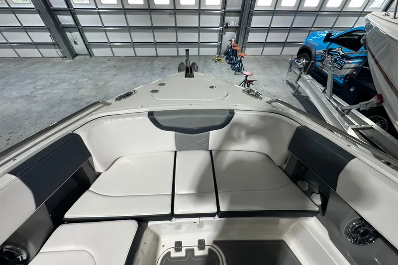 Slide: The Image of 2021 Chaparral 347 SSX boat interior with spacious seating in a garage setting. - 27
