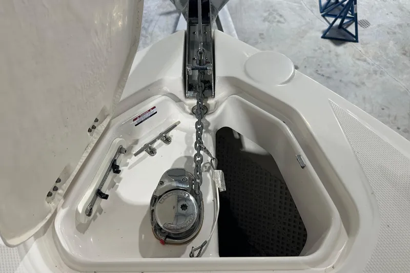 Slide: The Image of Anchor compartment of 2021 Chaparral 347 SSX boat, featuring chain and winch system. - 30