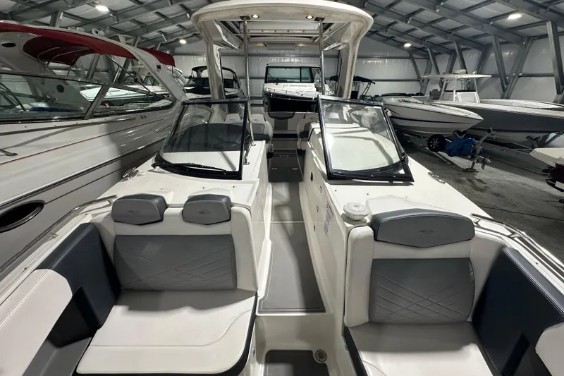 Slide: The Image of 2021 Chaparral 347 SSX boat interior in a showroom, featuring sleek seating and modern design. - 31