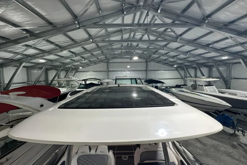 Slide: The Image of 2021 Chaparral 347 SSX boat in a spacious indoor storage facility. - 33