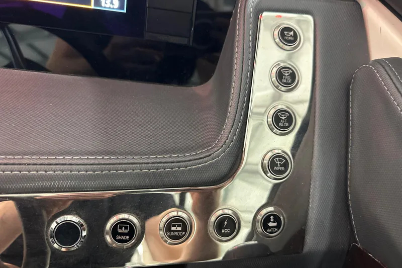 Slide: The Image of Control panel of 2021 Chaparral 347 SSX boat with various function buttons. - 38
